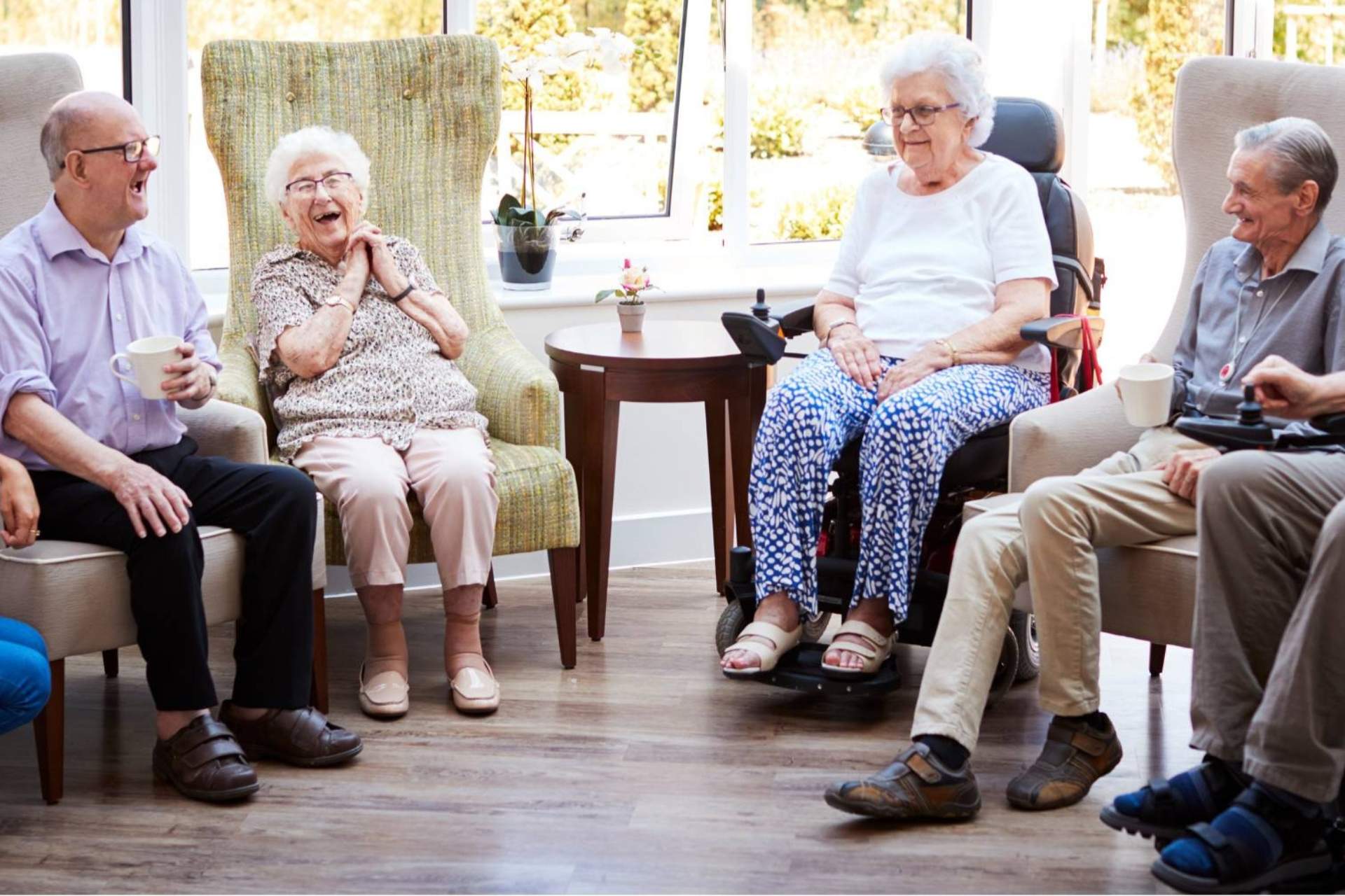 A group of seniors sitting together, laughing.