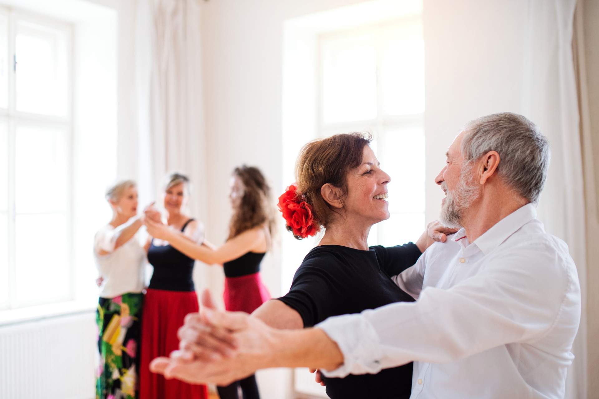 A group of seniors taking a dance class.